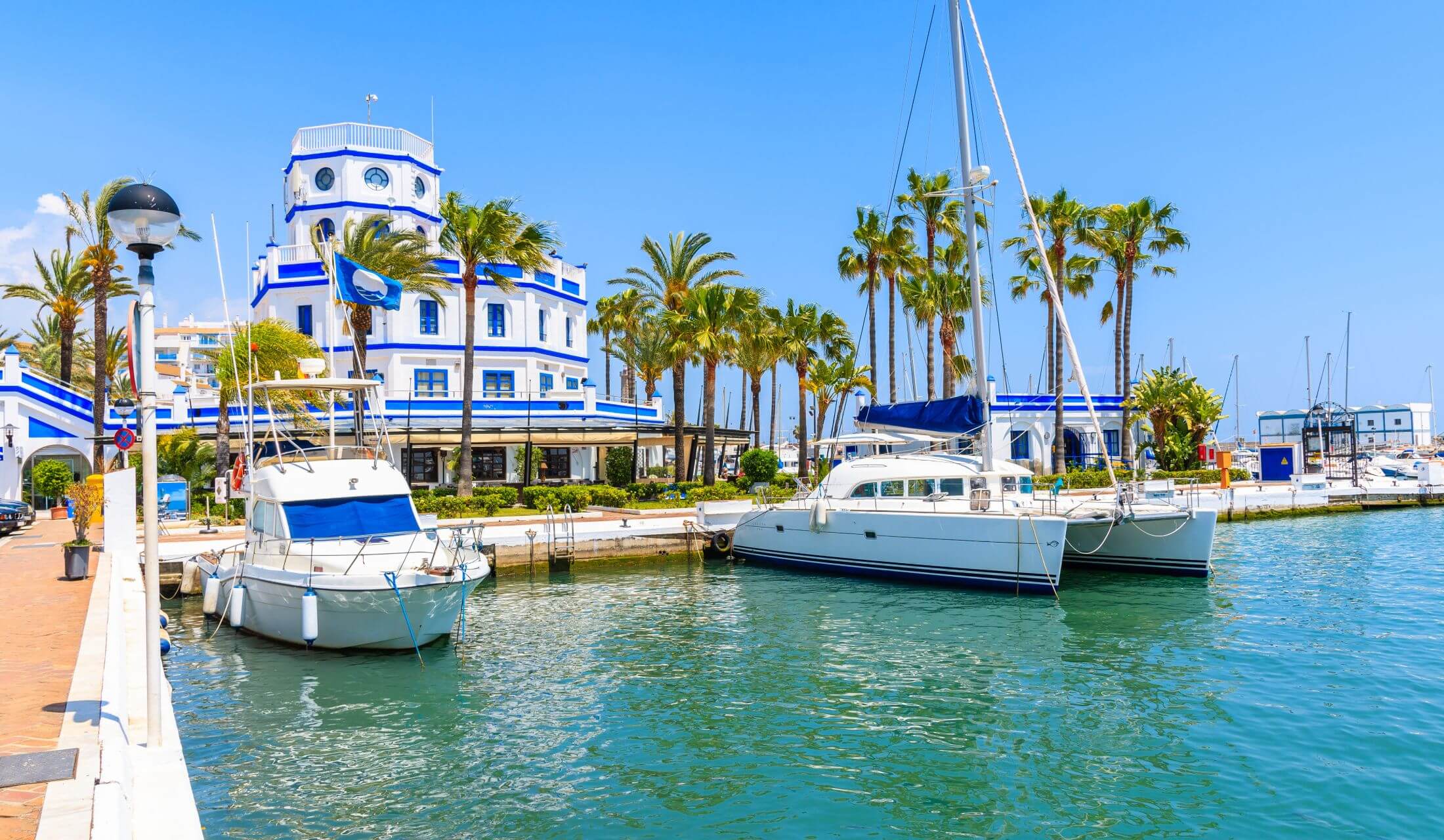 Boats And Beautiful Lighthouse Building In Estepona Port On Costa Del Sol Coast Spain 