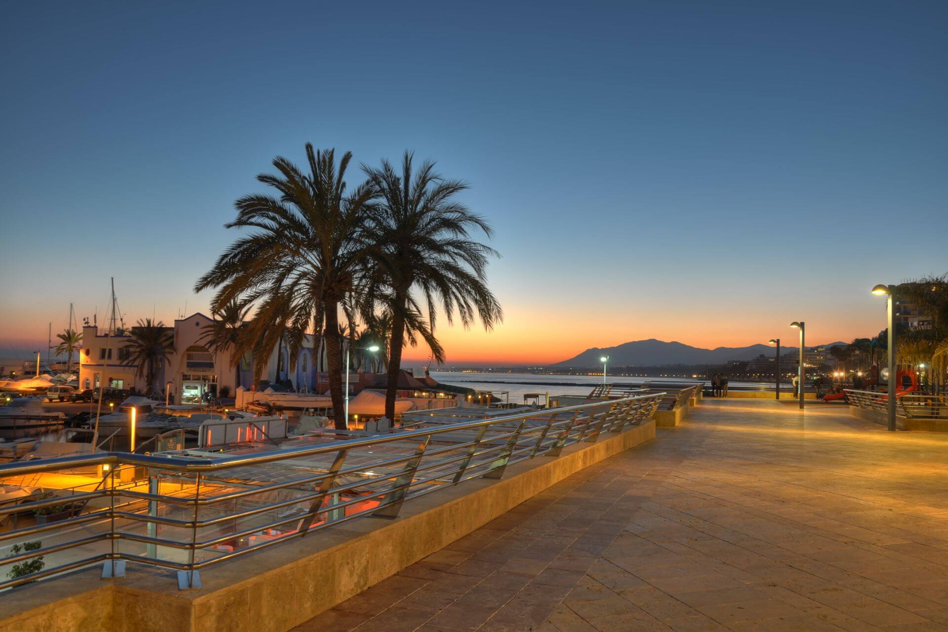 Marbella harbor and cliff at sunset - Realista Investments